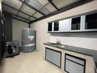 Utility room with washer and water tank