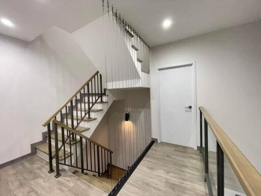 Staircase with modern decor and railing