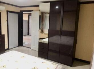 Bedroom with wardrobe and open door to another room