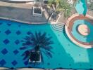 Outdoor swimming pool with palm trees and seating area