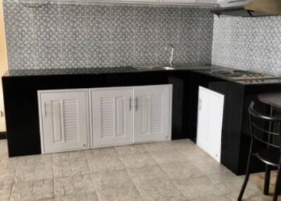 Modern kitchen with tiled backsplash and black-and-white cabinetry