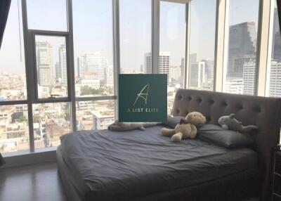 Modern bedroom with a large window and city view