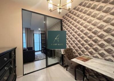 Room with accent wallpaper, glass doors, and chandelier