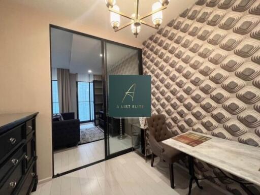 Room with accent wallpaper, glass doors, and chandelier