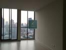 Empty living room with large windows offering city view