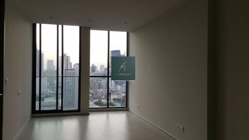 Empty living room with large windows offering city view