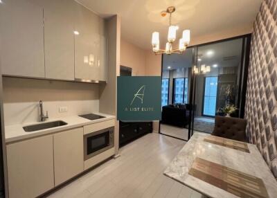 Modern kitchen with adjacent dining area and view of living room