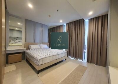 Spacious modern bedroom with bed and large windows