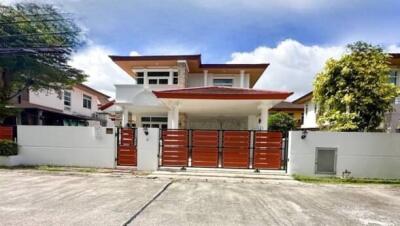 Front view of a modern house with a gated fence