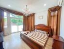 Spacious bedroom with wooden bed frame and large windows