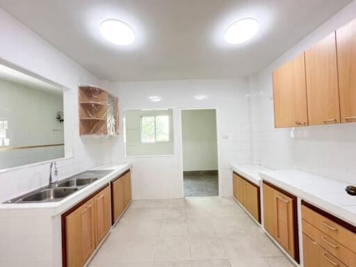 Modern kitchen with wooden cabinets and dual sinks