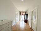 Hallway with bright light and wooden flooring