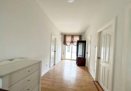 Hallway with bright light and wooden flooring