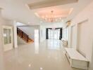 Spacious living room with chandelier and staircase