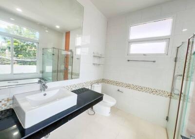 Modern bathroom with large mirror and glass shower