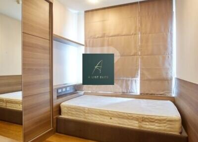 Minimalist bedroom with wooden flooring and built-in wardrobe