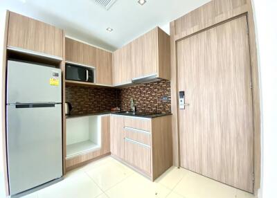 Modern kitchen with wooden cabinetry and appliances