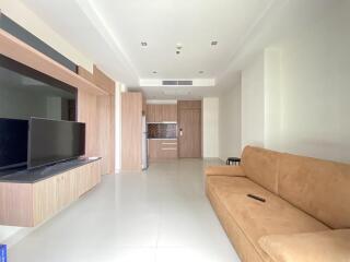 Modern living room with integrated kitchen area and beige couch