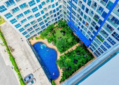 Aerial view of apartment building with swimming pool and garden