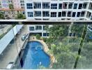 View from the balcony overlooking a swimming pool