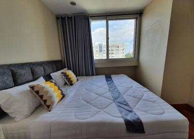 Modern bedroom with large bed and window view