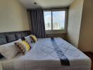 Modern bedroom with large bed and window view