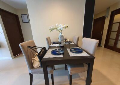 Dining area with table and chairs set up for a meal