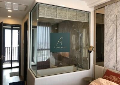 Bedroom with ensuite glass-walled bathroom