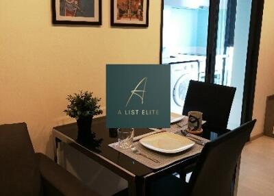 Cozy dining area with table set for two, adjacent to kitchen