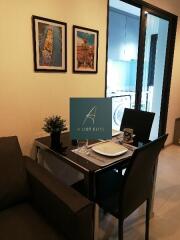 Cozy dining area with table set for two, adjacent to kitchen