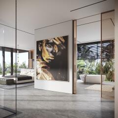 Modern living area with large artwork, floor-to-ceiling windows, and views of a lush outdoor space