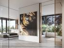 Modern living area with large artwork, floor-to-ceiling windows, and views of a lush outdoor space