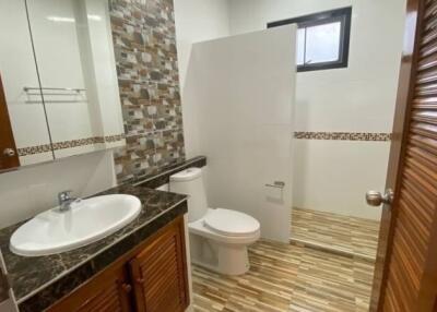 Modern bathroom with sink, toilet, and shower