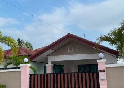 Front view of a house with gated entrance and driveway