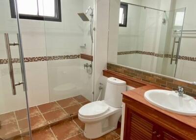 modern bathroom with glass shower and large mirror