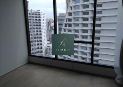 Bedroom with large windows and city view