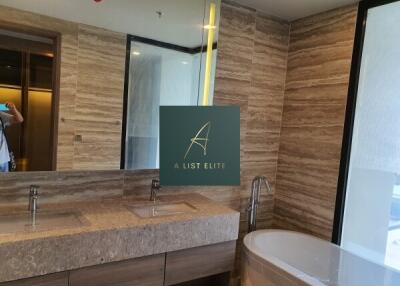 Modern bathroom with dual sinks and a bathtub