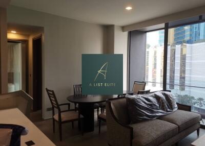 Modern living room with large windows and dining area