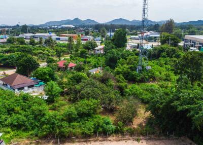 Aerial view of vegetated land and surrounding infrastructure