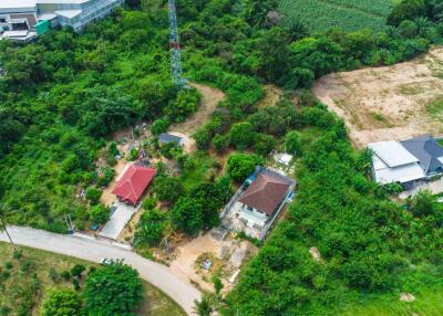 Aerial view of rural area with a few houses and greenery