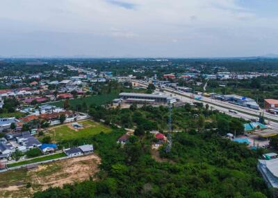 Aerial view of a residential neighborhood with surrounding greenery