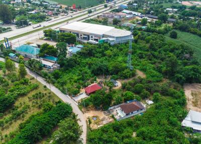 Aerial view of a property surrounded by greenery and buildings