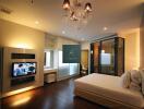 Modern bedroom with chandelier and TV