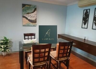 Dining room with glass table and framed art