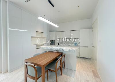 Modern kitchen with dining table and contemporary lighting