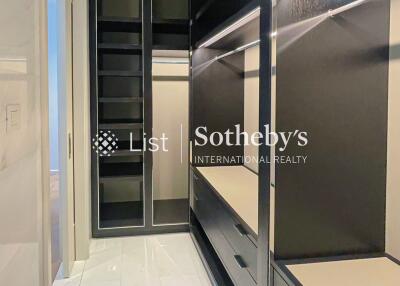 Spacious walk-in closet with built-in shelves and drawers