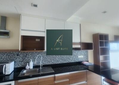 Modern kitchen with wooden cabinets and black countertop