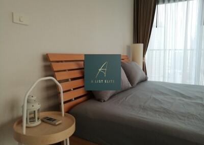 Cozy bedroom with a wooden headboard and side table