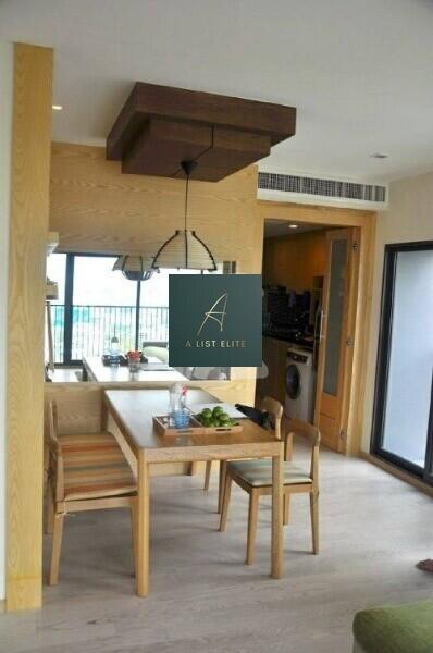 Modern dining area with wooden furniture and stylish lighting