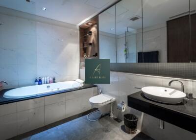 Modern bathroom with bathtub, sink, and toilet